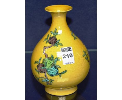 A Chinese glazed pottery oviform vase, decorated with coconut trees on yellow ground, six black character marks to base, 17cm