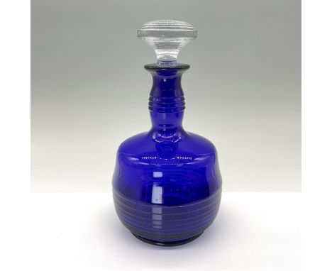 A beautiful, sleek cobalt blue decanter with graduated ring detailing, complemented by a clear glass stopper. Issued: 20th ce