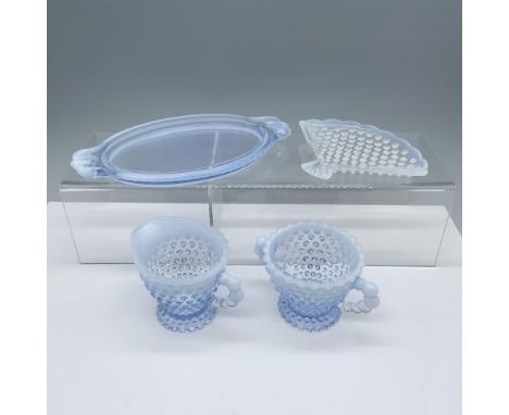 Magnificent collection of opaque glassware that consists of a small dessert tray, a seashell shaped tray, a creamer jug, and 