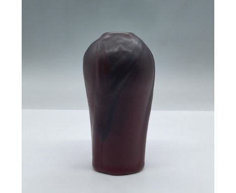 This small vintage ceramic vase from the 1920's features a bulbous design and simple floral relief with a maroon and mulberry