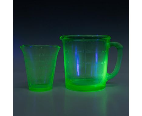 Uranium green glass paneled pitcher with a 4-cup capacity, accompanied by a graduated measuring cup with three spouts. A and 