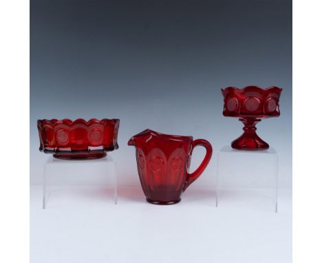 Handblown set of ruby red glassware that includes a scalloped edge bowl, a pitcher, and a pedestaled candy dish. Largest item