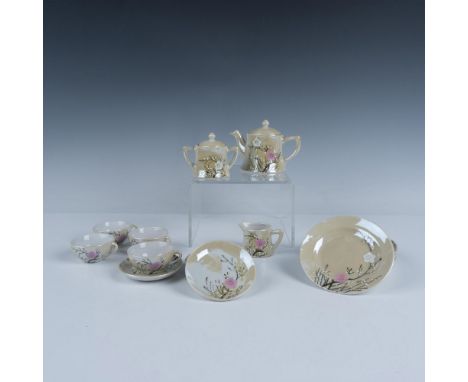 Lovely cherry blossom decorated tea set that includes a tea pot with a lid, a sugar jar with a lid, a creamer jug, four tea c