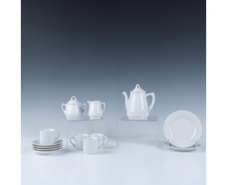 Splendid collection of white tableware that includes a pitcher for coffee or tea, a sugar jar with a lid, a creamer jug, four