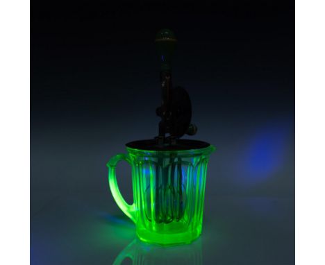 Green glass pitcher with metal top attached to beaters and hand crank. Marked A &amp; J. Issued: 20th centuryDimensions: 12.7