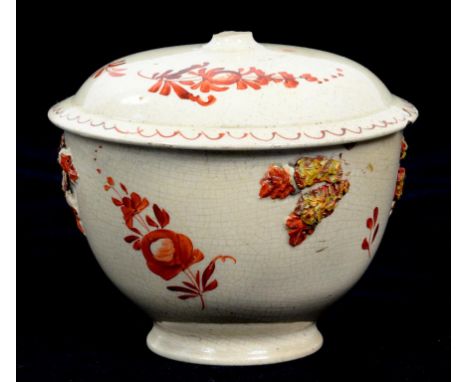 AN ENGLISH CREAMWARE SUCRIER AND COVER PAINTED IN RED MONOCHROME WITH A STYLISED FLOWER, 9CM H, CIRCA 1780, LACKS HANDLES AND