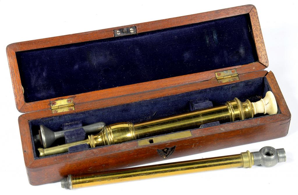 A VICTORIAN LACQUERED BRASS ENEMA SYRINGE WITH TURNED IVORY PLUNGER ...