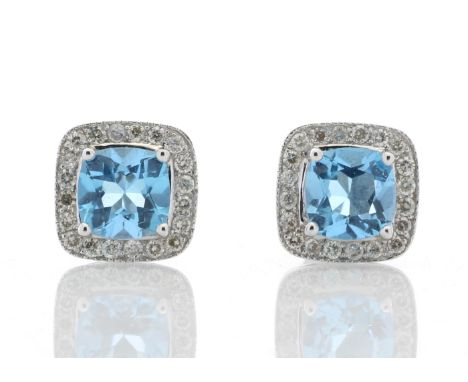 These classic 9ct white gold stud earrings are made up of two radiant cut blue topaz gemstone are surrounded by a halo of rou