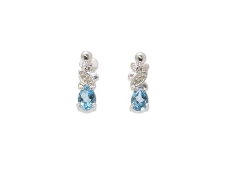 Two pear shaped blue topaz gemstones are set with a round brilliant cut diamonds resting on top in these adorable 9ct white g