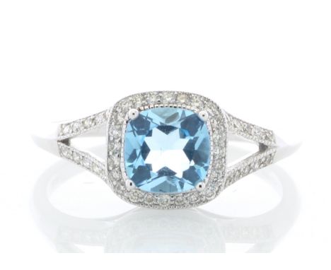 One cushion cut blue topaz is surrounded by forty four diamonds set in the halo and the split top shoulders. Ring size N.Item