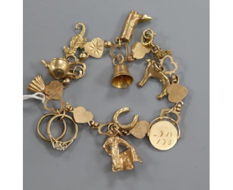 A 9ct gold charm bracelet, hung with eleven assorted charms including 9ct gold.