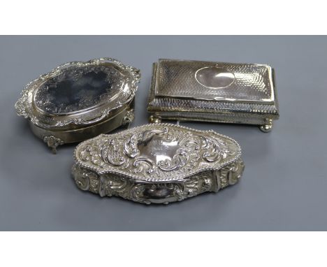 Three large silver trinket boxes, including one rectangular planished box with oval vacant cartouche, on bun feet, London 190