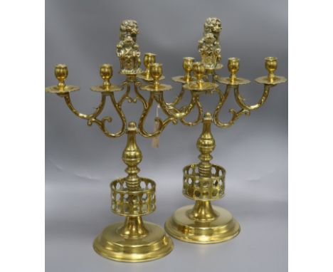 A pair of late Victorian cast brass four light candelabra