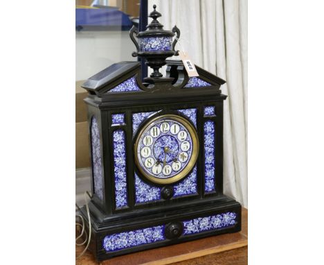A Victorian aesthetic movement ebonised, blue and white ceramic mounted 8-day mantel clock