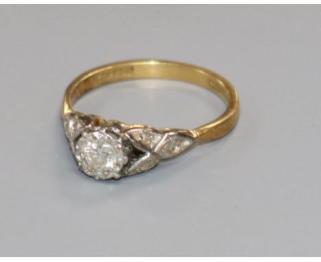 A Bravingtons 18ct gold and platinum, illusion set single stone diamond ring with diamond set shoulders, size L.