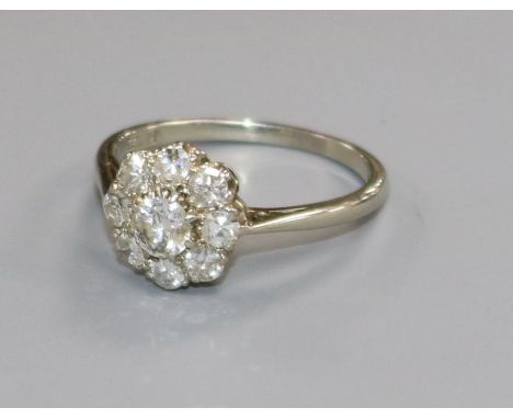 An 18ct white gold and diamond cluster flower head ring, size L.