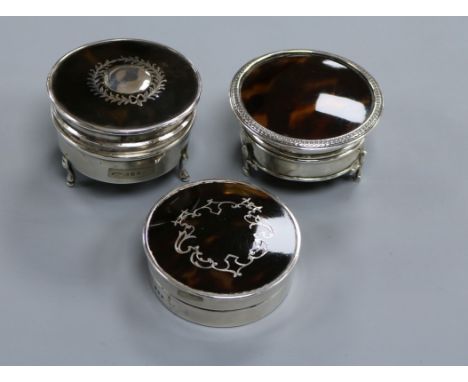 Three circular silver and tortoiseshell trinket boxes, two with pique decoration, including one with wreath and boss decorati