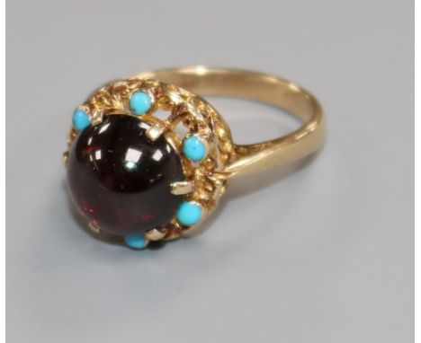 A 9ct gold, cabochon garnet and turquoise dress ring, size N/O