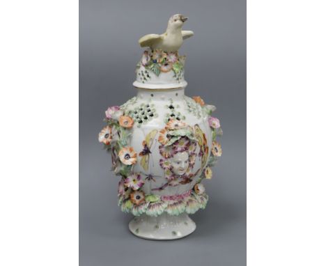 A Derby frill vase and cover, c.1760, of baluster form, the cover with bird finial, the floral-encrusted body with mask handl