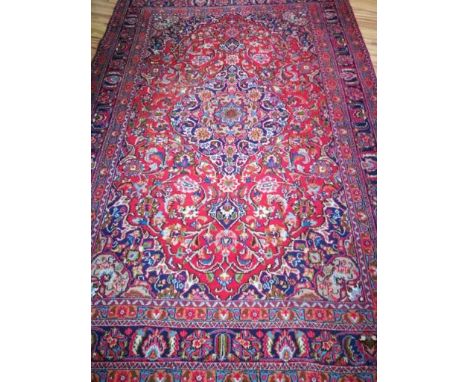 A Tabriz style red and blue ground carpet