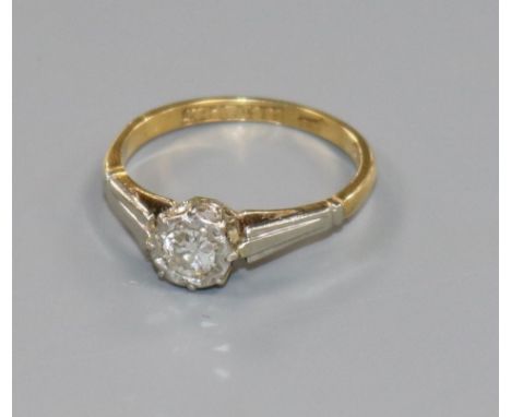 An early 20th century 18ct gold, platinum and illusion set solitaire diamond ring, size J/K.