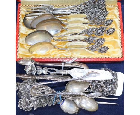 A small quantity of assorted Continental white metal flatware and a pair of English silver sugar tongs.