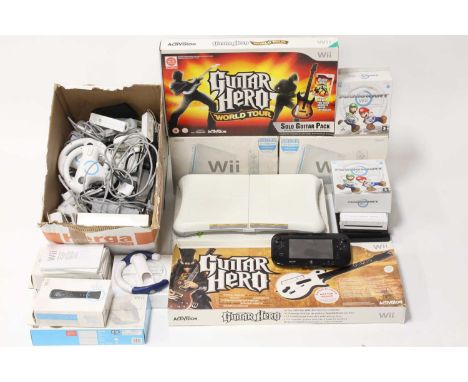 A collection of mixed Nintendo Wii games consoles, controllers, accessories, Wii Fit playboards, and other related console ac