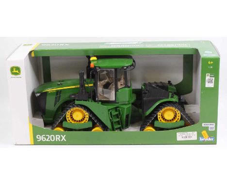 A Bruder 1/16 scale plastic and diecast model of a John Deere 9620 RX tracked tractor housed in the original open front card 