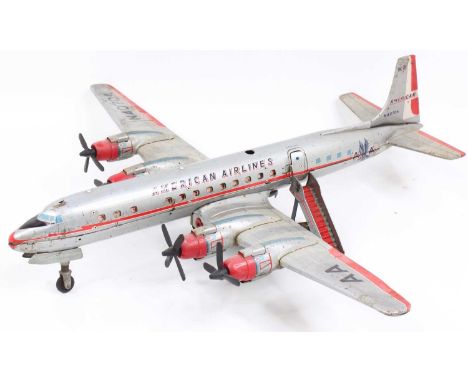 A large scale tin plate and battery operated Yonezawa of Japan tin plate Amercian DC7C American Airlines passenger aircraft, 