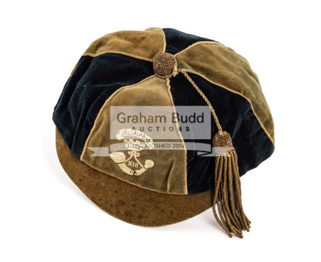 A unusual sporting cap issued in Jellalabad, Afghanistan in 1896,the quartered cap inscribed JELLALABAD XIII, with moitf inco