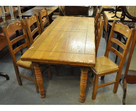 Modern French style pine dining or kitchen table with a set of six pine ladder back chairs on rush seats. (7)(B.P. 21% + VAT)