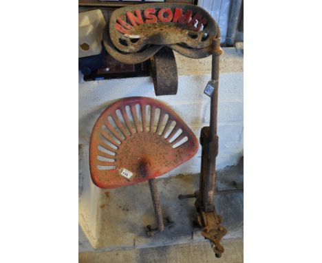 Three vintage cast iron tractor seats marked Ransomes and Bamfords. Together with a cast iron clamp/vice. (4) (B.P. 21% + VAT