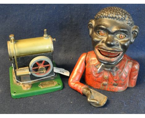 Cast iron black man money box, together with a tin plate 'Model Junior' steam engine. (2)(B.P. 21% + VAT) 