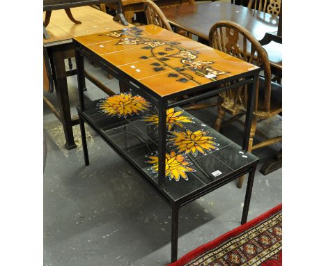 Two similar mid Century tile top coffee tables on metal supports, with floral designs. (2)(B.P. 21% + VAT) 