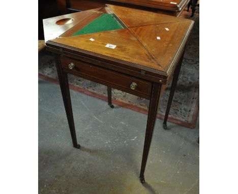 Edwardian mahogany inlaid envelope swivel card table with single pull out drawer standing on square tapering legs and casters