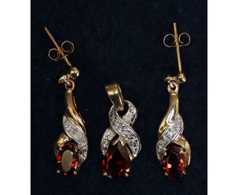 A pair of 9ct gold diamond and ruby drop earrings, together with a matching pendant.(B.P. 21% + VAT) 