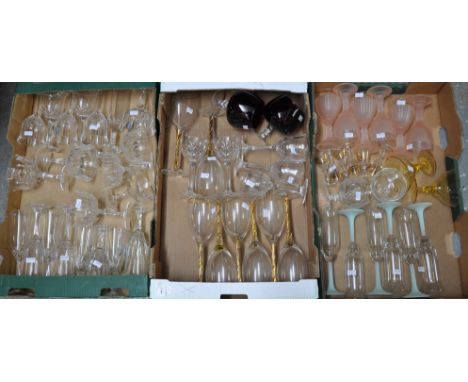 Three boxes of glasses to include; champagne bowls and champagne flutes, wine glasses, pink moulded wine glasses, green stemm