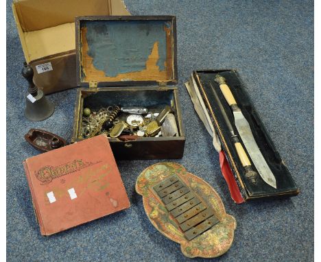 Box of oddments to include; carving set, miniature xylophone, table bell, cigarette album with portraits, wooden box containi