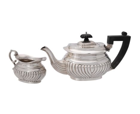 
	
		A silver half gadrooned oblong tea pot and cream jug by A. &amp; J. Zimmerman, Birmingham 1915, the tea pot with a compo