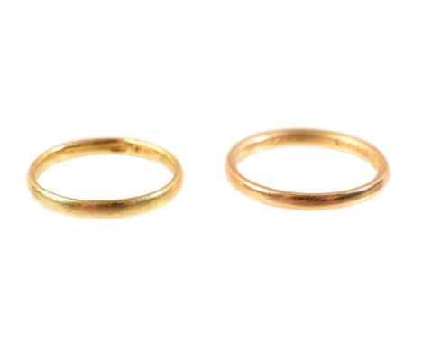 
	
		A 22 carat gold band ring, Birmingham 1938 hallmark, finger size N 1/2; and a further gold coloured wedding band, finger