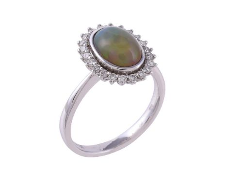 
	
		An opal and diamond cluster dress ring, the oval cabochon opal within a surround of brilliant cut diamonds, approximatel