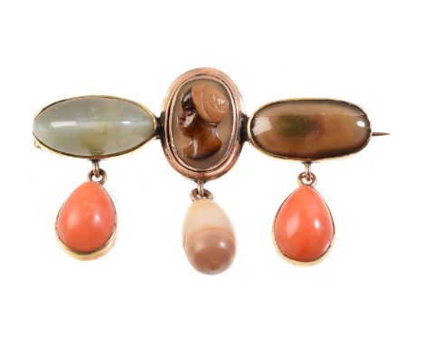 
	
		Y&nbsp;A coral, pearl and hardstone brooch, the central panel carved with the profile of a Moor wearing a turban, flanke