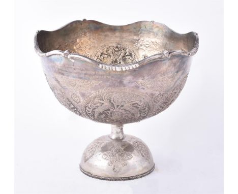 
	
		A Pakistani large silver coloured pedestal bowl, unmarked, 1950s, with a scroll border, chased and engraved with birds, 