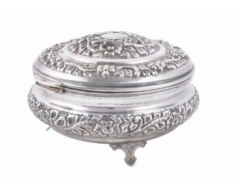 
	
		An Egyptian silver coloured circular hinged box and cover, date code for 1975-76, stamped 90, chased with foliate and fl