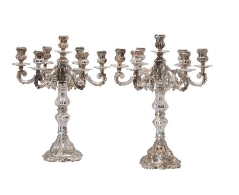 
	
		A pair of Italian silver coloured candelabra, 1944 - 1968 .800 standard, with lobed baluster capitals, six scroll branch