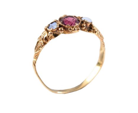 
	
		A Victorian garnet and opal three stone ring, the central rhodelite garnet flanked by a pair of circular cabochon opals,