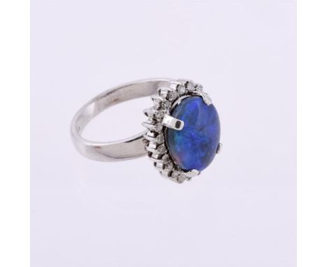 
	
		A diamond and opal cluster ring, the oval cabochon opal within a surround of eight cut diamonds, approximately 0.22 cara