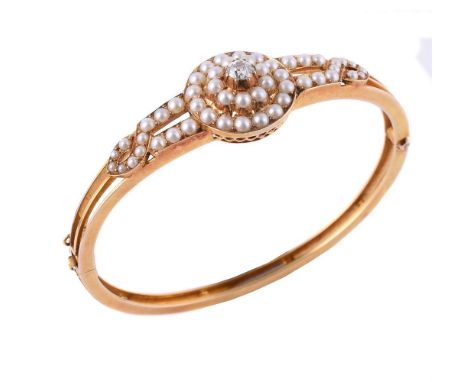
	
		A late Victorian diamond and half pearl hinged bangle, the front with a target cluster of half pearls centred with an ol