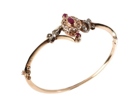 
	
		A ruby and diamond hinged bangle, the central ruby and rose cut diamond cluster to rose cut diamond set scrolled crossov