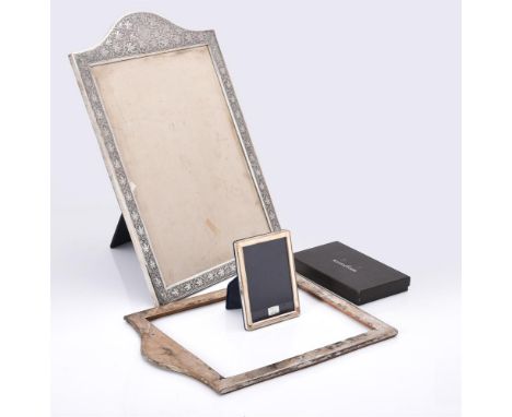 
	
		A silver coloured mounted photo frame, unmarked, chased with foliate swags, engraved with a star and crescent moon withi